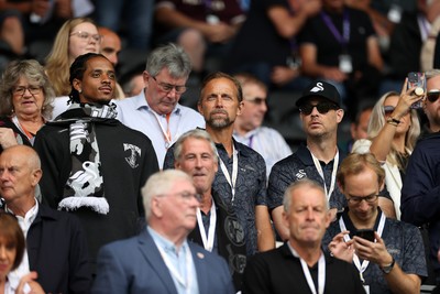 230825 - Swansea City v Watford FC - SkyBet Championship - Snoop Dogg�s son Cordell Broadus watches the game from the stands with Swansea City owner and shareholder Brett Cravatt and Scott Hochstadt