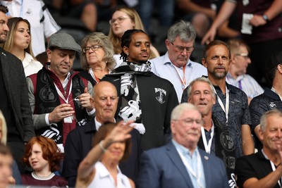 230825 - Swansea City v Watford FC - SkyBet Championship - Snoop Dogg�s son Cordell Broadus watches the game from the stands with Swansea City owner and shareholder Brett Cravatt