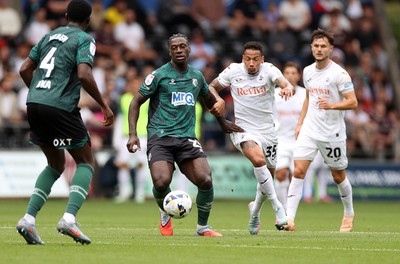 230825 - Swansea City v Watford FC - SkyBet Championship - James Abankwah of Watford is challenged by Ronald of Swansea City 