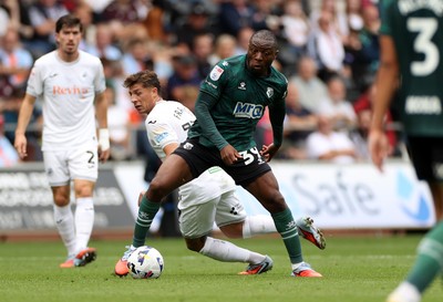 230825 - Swansea City v Watford FC - SkyBet Championship - Edo Kayembe of Watford is challenged by Goncalo Franco of Swansea City 