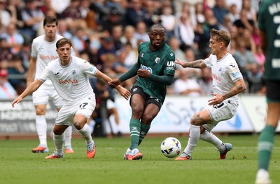 230825 - Swansea City v Watford FC - SkyBet Championship - Edo Kayembe of Watford is challenged by Goncalo Franco and Ethan Galbraith of Swansea City 