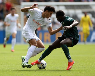 230825 - Swansea City v Watford FC - SkyBet Championship - Marko Stamenic of Swansea City is challenged by Jeremy Ngakia of Watford 