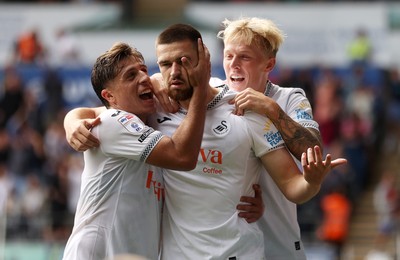 230825 - Swansea City v Watford FC - SkyBet Championship - Zan Vipotnik of Swansea City celebrates scoring a goal with team mates Goncalo Franco and Melker Widell