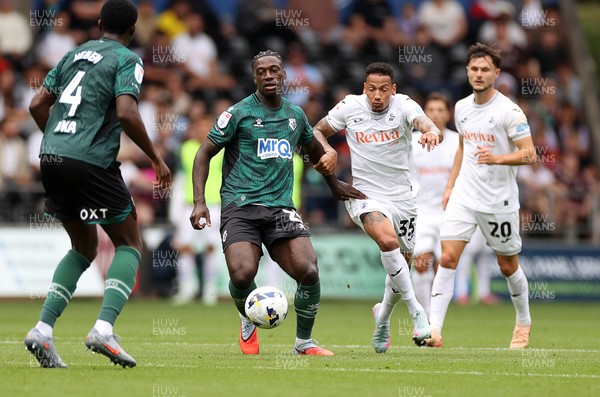 230825 - Swansea City v Watford FC - SkyBet Championship - James Abankwah of Watford is challenged by Ronald of Swansea City 