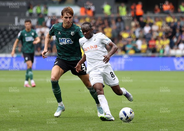230825 - Swansea City v Watford FC - SkyBet Championship - Malick Yalcouye of Swansea City is challenged by Hector Kyprianou of Watford 