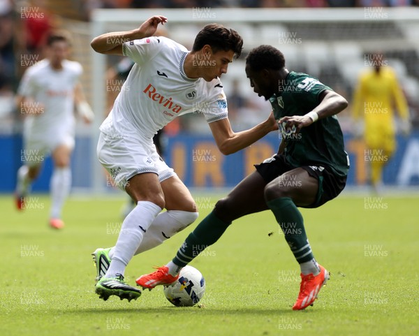 230825 - Swansea City v Watford FC - SkyBet Championship - Marko Stamenic of Swansea City is challenged by Jeremy Ngakia of Watford 