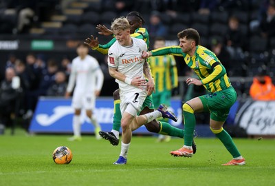 110126 - Swansea City v West Bromwich Albion - FA Cup Third Round - Melker Widell of Swansea City is tackled by Ousmane Diakite and Chris Mepham of West Brom 