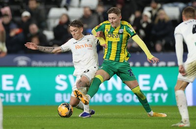 110126 - Swansea City v West Bromwich Albion - FA Cup Third Round - Ethan Galbraith of Swansea City is challenged by Ollie Bostock of West Brom 
