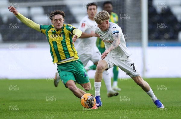 110126 - Swansea City v West Bromwich Albion - FA Cup Third Round - Melker Widell of Swansea City is challenged by Callum Styles of West Brom 