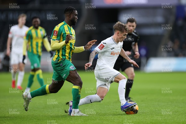 110126 - Swansea City v West Bromwich Albion - FA Cup Third Round - Ethan Galbraith of Swansea City is challenged by Daryl Dike of West Brom 