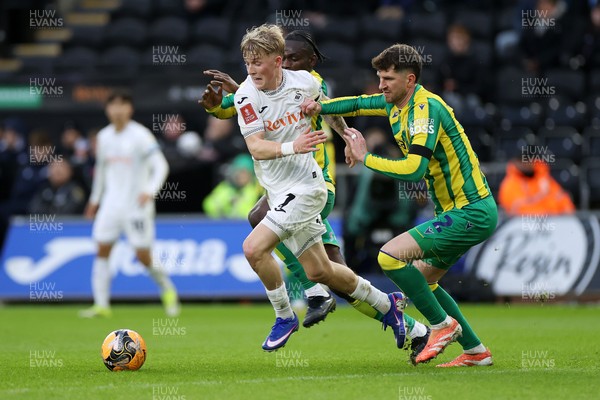 110126 - Swansea City v West Bromwich Albion - FA Cup Third Round - Melker Widell of Swansea City is tackled by Ousmane Diakite and Chris Mepham of West Brom 