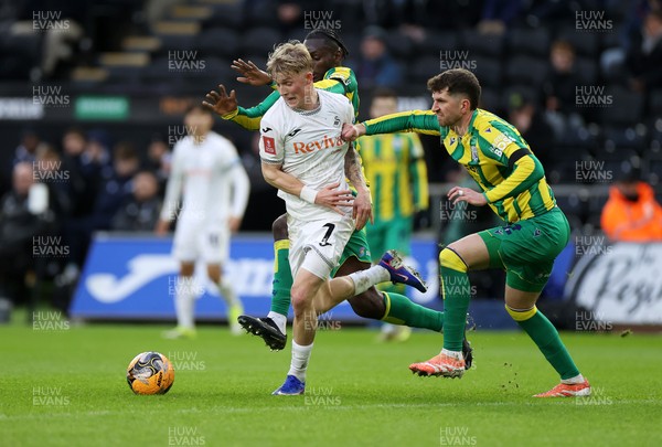 110126 - Swansea City v West Bromwich Albion - FA Cup Third Round - Melker Widell of Swansea City is tackled by Ousmane Diakite and Chris Mepham of West Brom 