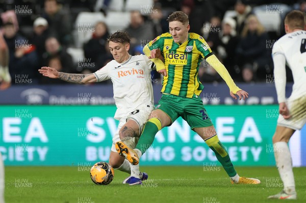 110126 - Swansea City v West Bromwich Albion - FA Cup Third Round - Ethan Galbraith of Swansea City is challenged by Ollie Bostock of West Brom 