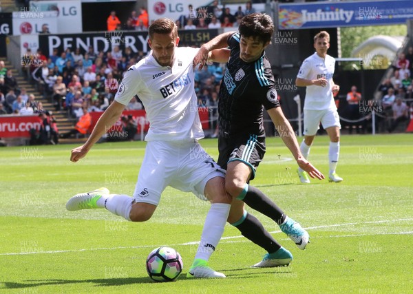 210517 - Swansea City v West Bromwich Albion, Premier League - Gylfi Sigurdsson of Swansea City gets a shot at goal as Claudio Yacob of West Bromwich Albion closes in