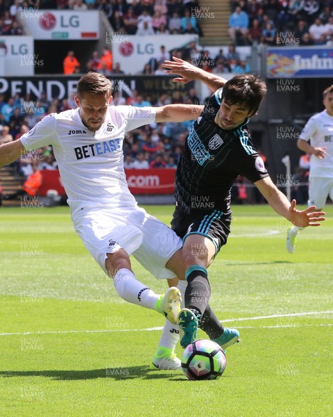 210517 - Swansea City v West Bromwich Albion, Premier League - Gylfi Sigurdsson of Swansea City gets a shot at goal as Claudio Yacob of West Bromwich Albion closes in