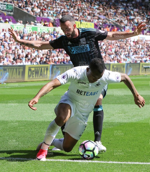 210517 - Swansea City v West Bromwich Albion, Premier League -Jordan Ayew of Swansea City is challenged by Marc Wilson of West Bromwich Albion