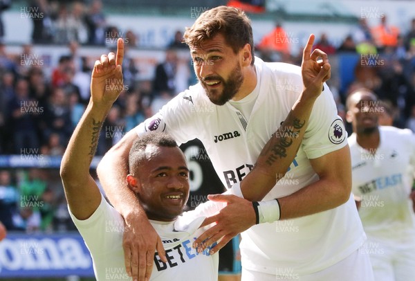 210517 - Swansea City v West Bromwich Albion, Premier League - Jordan Ayew of Swansea City  celebrates with Fernando Llorente and Federico Fernandez of Swansea City after scoring goal