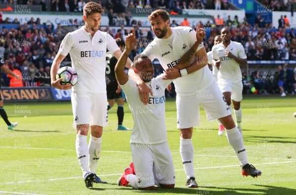 210517 - Swansea City v West Bromwich Albion, Premier League - Jordan Ayew of Swansea City  celebrates with Fernando Llorente and Federico Fernandez of Swansea City after scoring goal