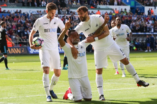 210517 - Swansea City v West Bromwich Albion, Premier League - Jordan Ayew of Swansea City  celebrates with Fernando Llorente and Federico Fernandez of Swansea City after scoring goal