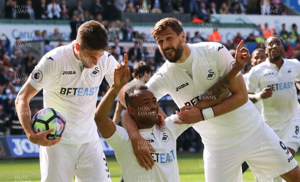 210517 - Swansea City v West Bromwich Albion, Premier League - Jordan Ayew of Swansea City  celebrates with Fernando Llorente and Federico Fernandez of Swansea City after scoring goal