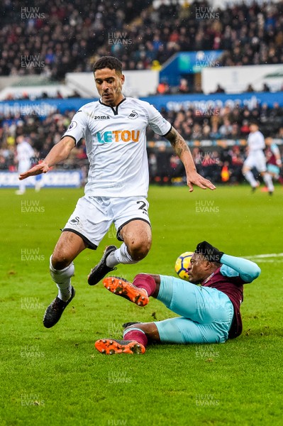 030318 - Swansea City v West Ham United  - Premier League - Kyle Naughton of Swansea City clashes with Patrice Evra of West Ham  