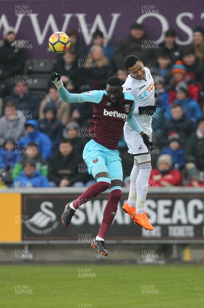 030318 - Swansea City v West Ham United, Premier League - Martin Olsson of Swansea City and Cheikhou Kouyate of West Ham United compete for the ball