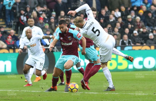 030318 - Swansea City v West Ham United, Premier League - Mike van der Hoorn of Swansea City and Winston Reid of West Ham United clash as they look to win the ball