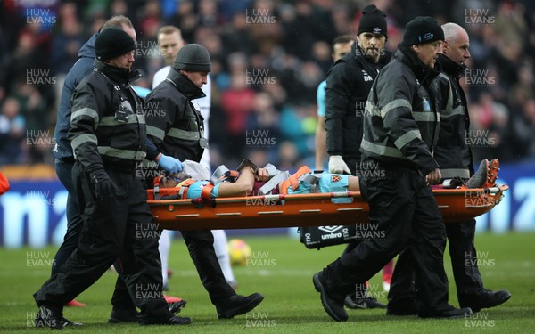 030318 - Swansea City v West Ham United, Premier League - Winston Reid of West Ham United is stretchered from the pitch