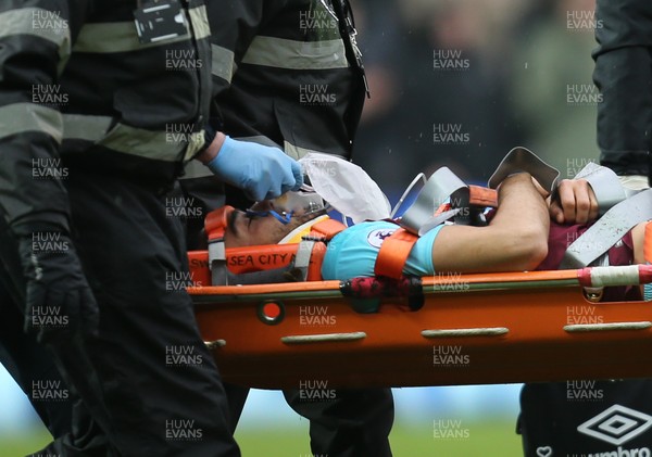 030318 - Swansea City v West Ham United, Premier League - Winston Reid of West Ham United is stretchered from the pitch