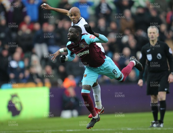 030318 - Swansea City v West Ham United, Premier League - Cheikhou Kouyate of West Ham United and Andre Ayew of Swansea City compete for the ball