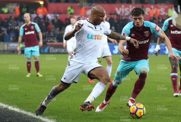 030318 - Swansea City v West Ham United, Premier League - Andre Ayew of Swansea City takes on Aaron Cresswell of West Ham United
