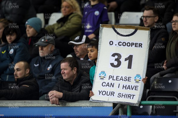 051122 - Swansea City v Wigan Athletic - Sky Bet Championship - A young Swansea City fan with a sign
