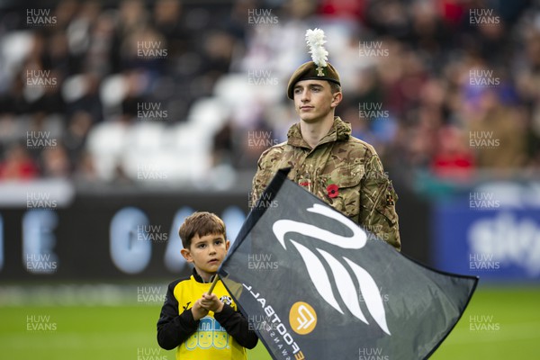 051122 - Swansea City v Wigan Athletic - Sky Bet Championship - A member of the armed forces on the pitch ahead of kick off