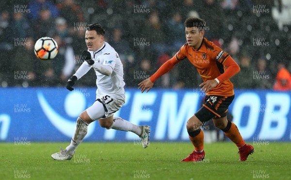 170118 - Swansea City v Wolverhampton Wanderers - FA Cup Replay - Roque Mesa of Swansea City is challenged by Morgan Gibbs-White of Wolverhampton Wanderers