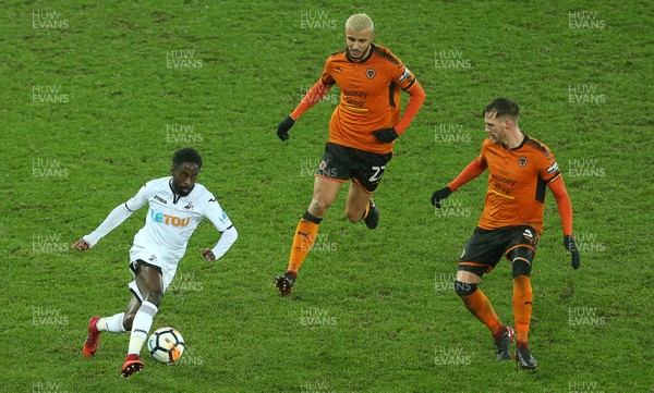 170118 - Swansea City v Wolverhampton Wanderers - FA Cup Replay - Nathan Dyer of Swansea City is challenged by Romain Saiss and Ryan Bennett of Wolverhampton Wanderers