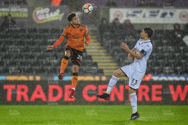 170118 - Swansea City v Wolverhampton Wonderers, FA CUP Replay - Morgan Gibbs White of Wolverhampton Wanderers jumps for the ball 