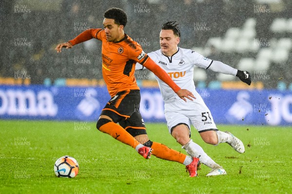 170118 - Swansea City v Wolverhampton Wonderers, FA CUP Replay - Roque Mesa of Swansea City chases down Morgan Gibbs-White of Wolverhampton Wanderers 