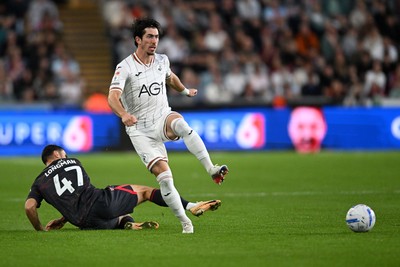 050926 - Swansea City v Wrexham - Sky Bet Championship - Josh Key of Swansea City is challenged by Ryan Longman of Wrexham