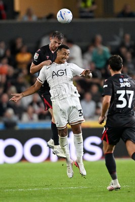 050926 - Swansea City v Wrexham - Sky Bet Championship - Dominic Hyam of Wrexham is challenged by Adam Idah of Swansea City