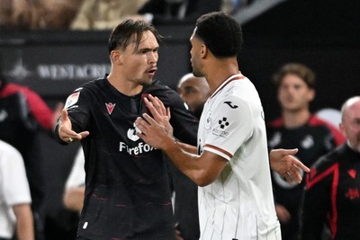 050926 - Swansea City v Wrexham - Sky Bet Championship - Callum Doyle of Wrexham and Ben Cabango of Swansea City have a disagreement 
