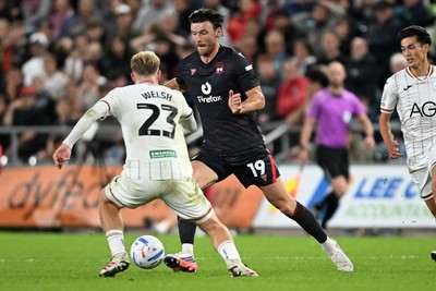 050926 - Swansea City v Wrexham - Sky Bet Championship - Kieffer Moore of Wrexham is challenged by Stephen Welsh of Swansea City
