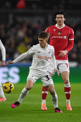 191225 - Swansea City v Wrexham - Sky Bet Championship - Kieffer Moore of Wrexham is challenged by Ethan Galbraith of Swansea City