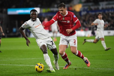 191225 - Swansea City v Wrexham - Sky Bet Championship - Zeidane Inoussa of Swansea City is challenged by Callum Doyle of Wrexham