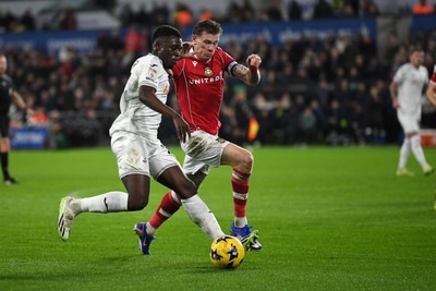 191225 - Swansea City v Wrexham - Sky Bet Championship - Zeidane Inoussa of Swansea City is challenged by James McClean of Wrexham
