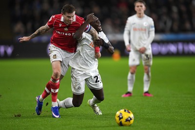 191225 - Swansea City v Wrexham - Sky Bet Championship - Zeidane Inoussa of Swansea City is challenged by James McClean of Wrexham