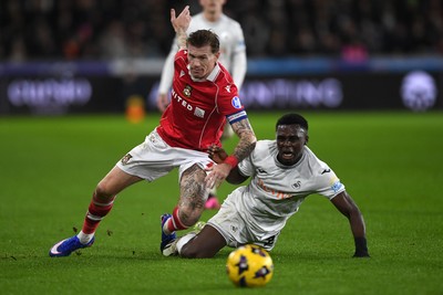 191225 - Swansea City v Wrexham - Sky Bet Championship - Zeidane Inoussa of Swansea City is challenged by James McClean of Wrexham