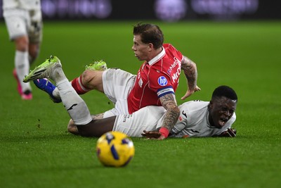 191225 - Swansea City v Wrexham - Sky Bet Championship - Zeidane Inoussa of Swansea City is challenged by James McClean of Wrexham