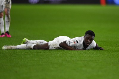 191225 - Swansea City v Wrexham - Sky Bet Championship - Zeidane Inoussa of Swansea City is challenged by James McClean of Wrexham