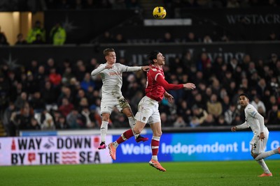 191225 - Swansea City v Wrexham - Sky Bet Championship - Ethan Galbraith of Swansea City is challenged by Kieffer Moore of Wrexham