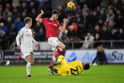 191225 - Swansea City v Wrexham - Sky Bet Championship - George Thomason of Wrexham is challenged by Lawrence Vigouroux of Swansea City